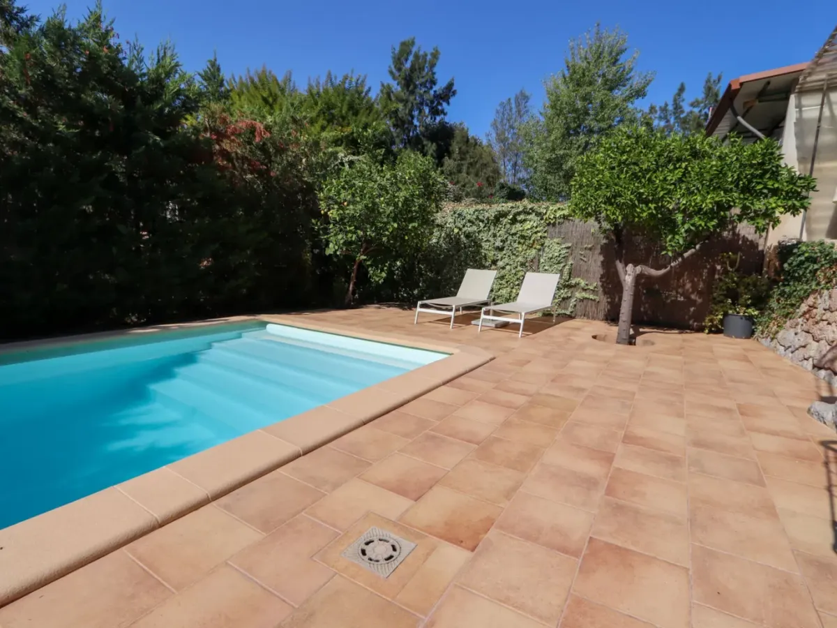 A two-apartment house on a quiet street, featuring a private pool