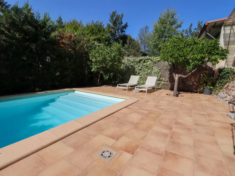 A two-apartment house on a quiet street, featuring a private pool